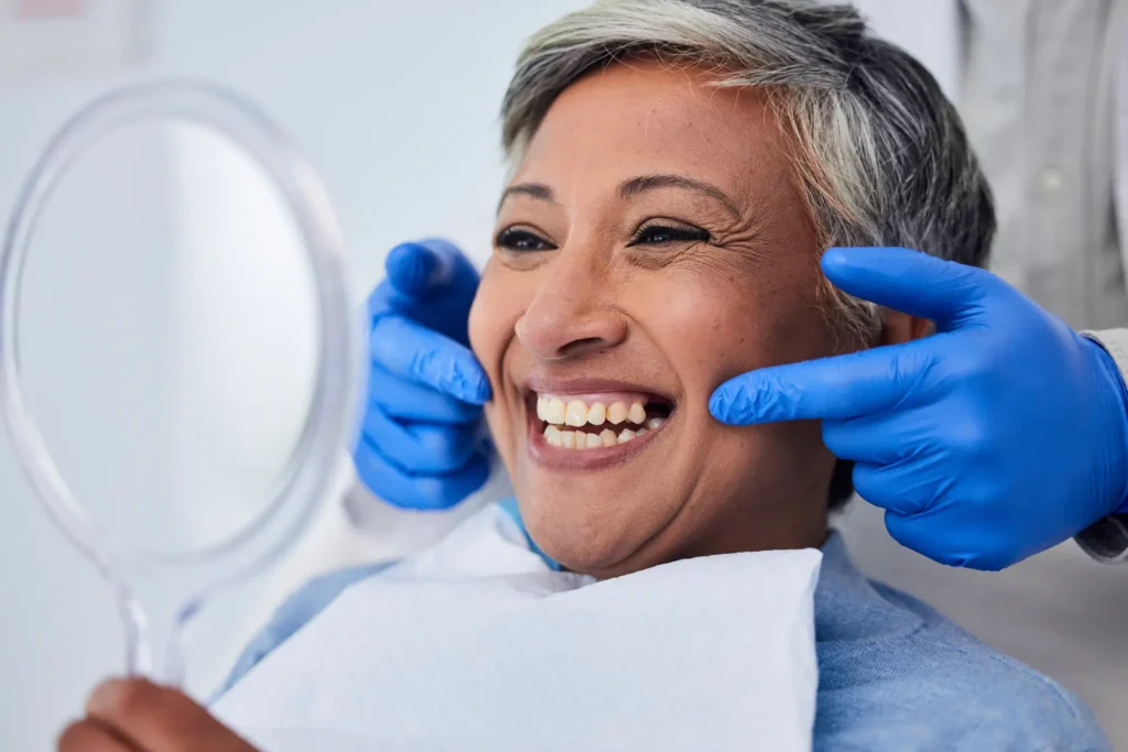 woman with new dentures at dental office